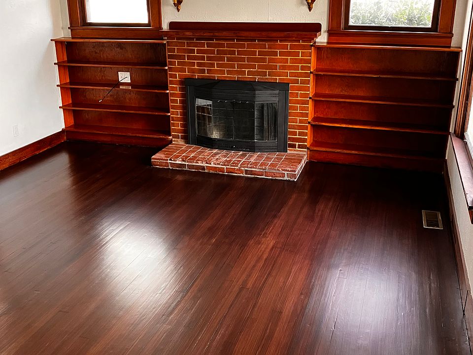 Living room with freshly done hardwood floors. Built in shelves