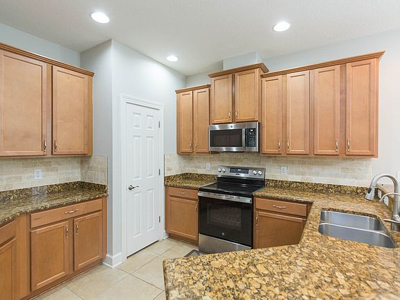 Chefs kitchen with granite counters, newer stainless steel appliances
