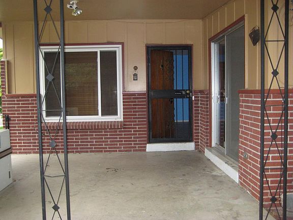 View of entry door and covered patio