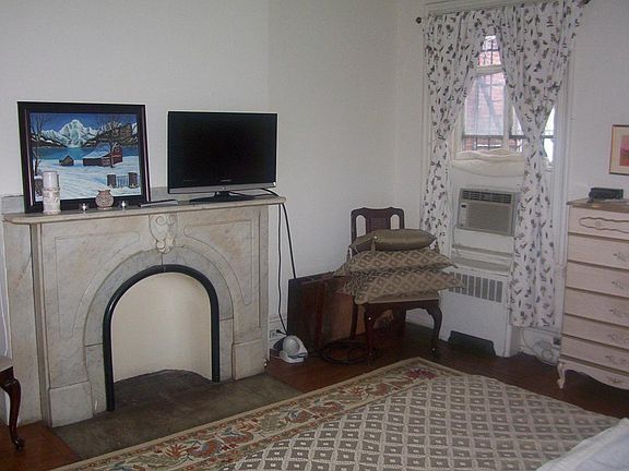 Bedroom w Decorative Fireplace