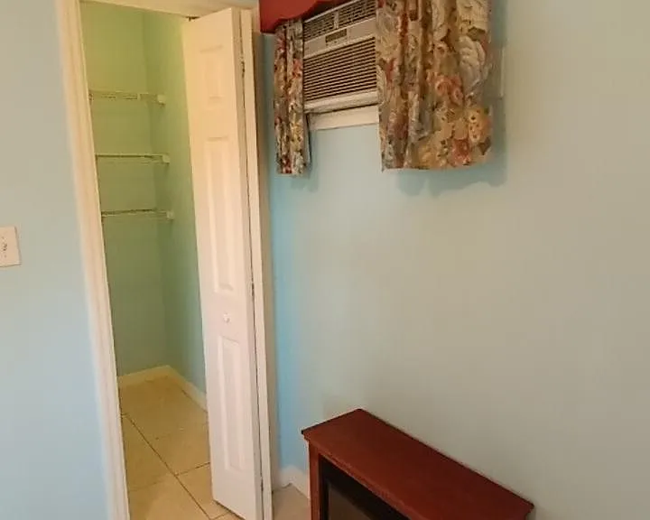 View of closet interior and optional fireplace unit in bedroom available for chilly days.