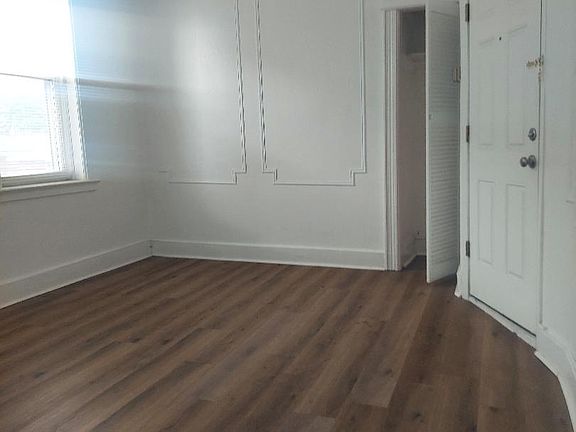 Living room with closet and entry door