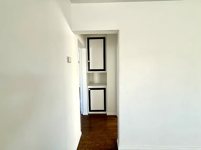 view of hallway built-in storage closets