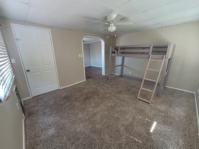 Sitting Room Off Primary Bedroom With Exit Door To Backyard