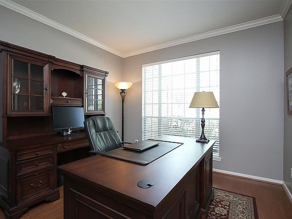 Large study with wood floors, crown molding, and french doors....beautiful!