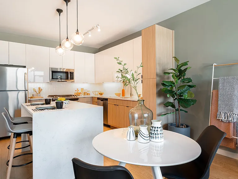 Bright, modern, and inviting this open kitchen and dining space at Eleven33 is perfect for quiet mornings, dinner with friends, or anything in between.