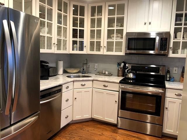 Kitchen with stainless steel appliances and granite counters