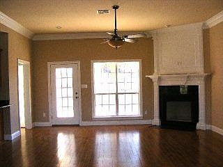 Wood floors and custom fireplace mantle.