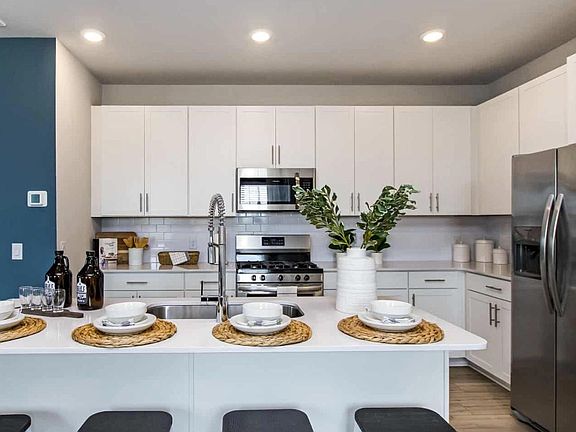 Kitchen showing island that seat four. Large double sink