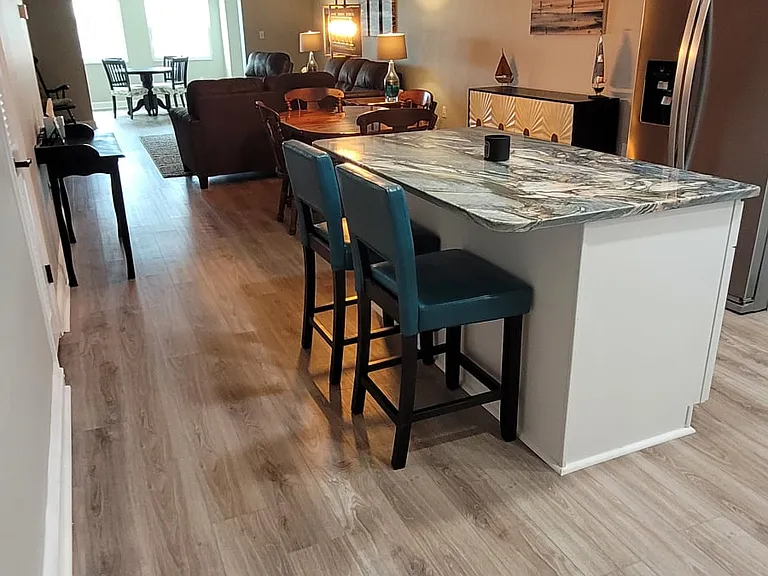 New flooring and renovated kitchen. This photo gives a good sense of how open and long this unit is.