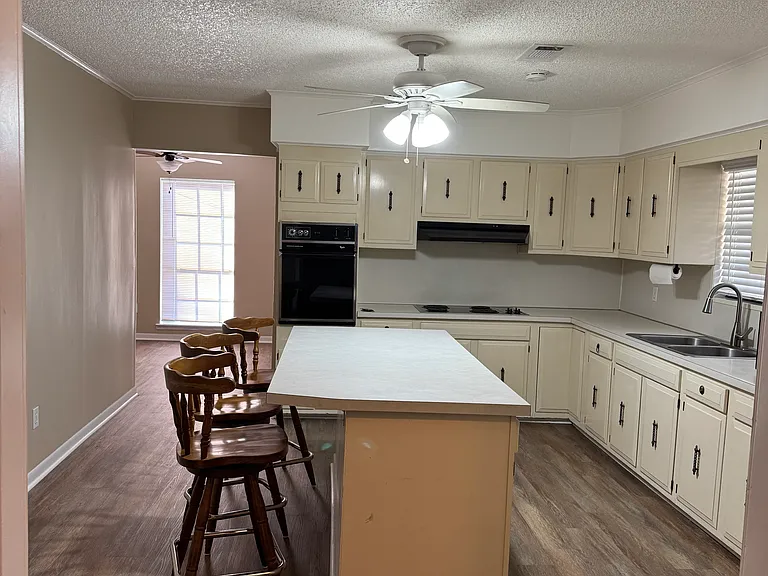 Kitchen has Island Bar with extra storage cabinets for your kitchen storage needs.