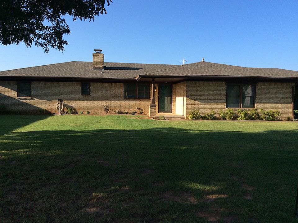 Brick home with large trees