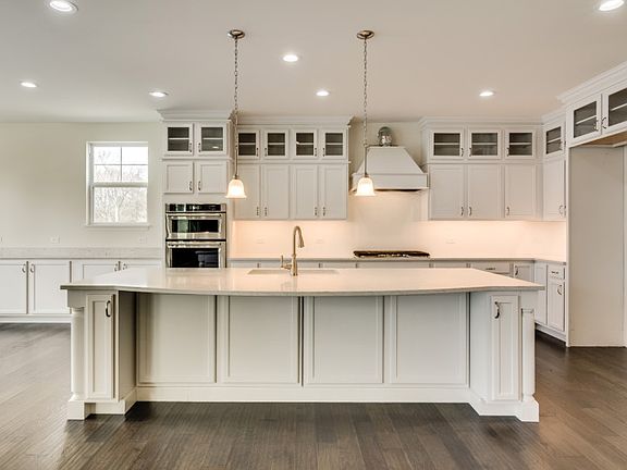 Kitchen with Built-in Stainless Steel Appliances and Designer Backsplash