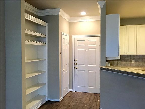 Entry with coat closet along with generous built-ins.