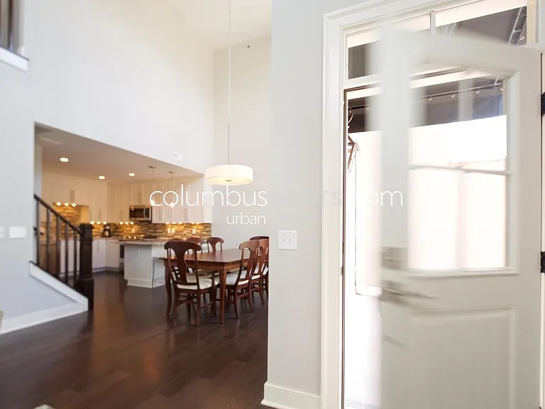 interior living room - main level with unit entry door shown opening to front porch patio