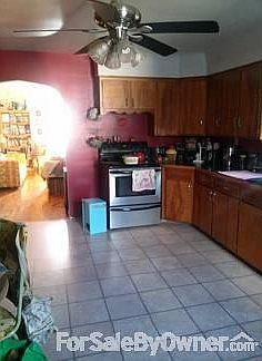 Open, Spacious Kitchen!
						:
						View of the kitchen from the breezeway entry. Pergo flooring is recent.