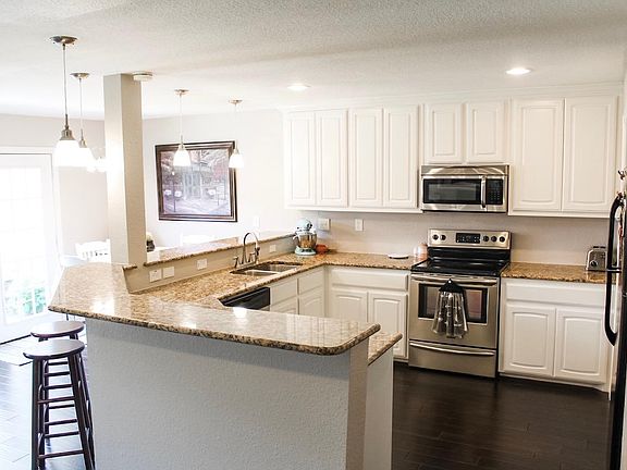Large Open Concept Kitchen with granite counter tops and stainless steel appliances
