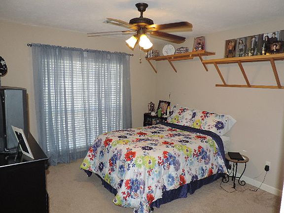 bedroom with display shelves