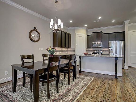 Dining area is between the kitchen and living room on the first floor.