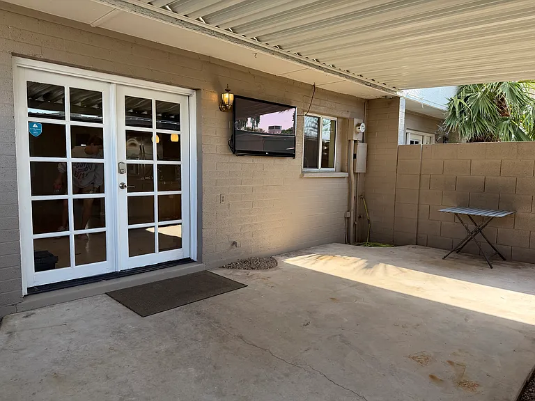 Covered private patio area. Included with mounted TV
