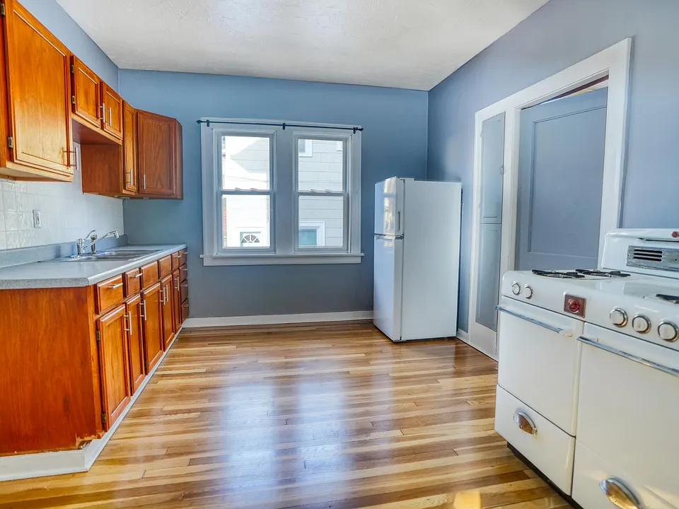 Kitchen with 1950's Magic Chef Oven/Range, updated Fridge, hardware, and freshly refinished original 1926 White Oak floors