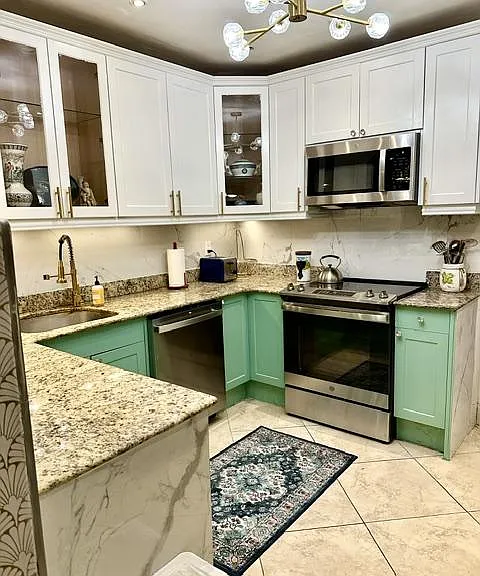 U-shaped kitchen with granite counters, stainless appliances, and ample cabinet storage for everyday cooking.