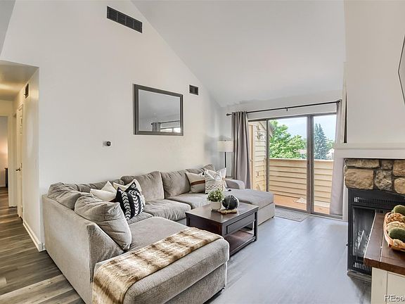 Front room with vaulted ceiling & patio access