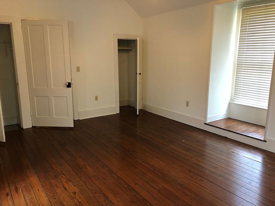 The bedroom has two closets and heart pine floors.