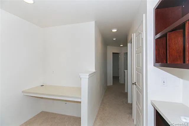 Hall way with built-in desk and shelves