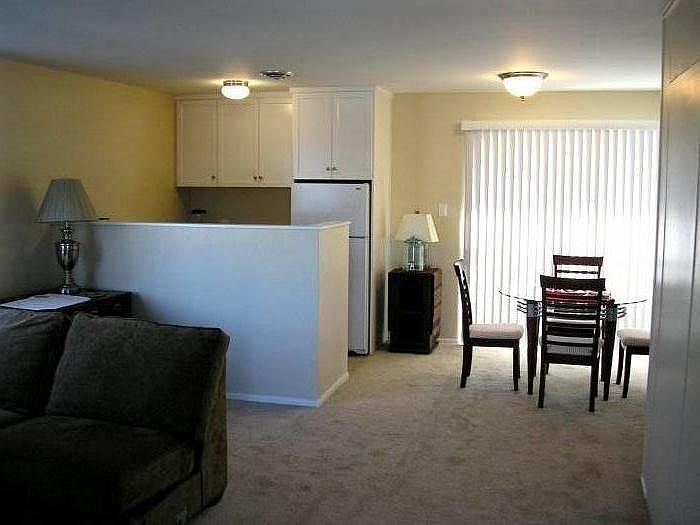 There is an open concept living room, dining room and kitchen. A large private deck is off the dining room. Alcove for an entertainment center or study desk is just to the right but off the picture.