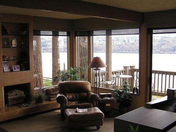 The living room has upgraded carpet & concrete fireplace with hearth