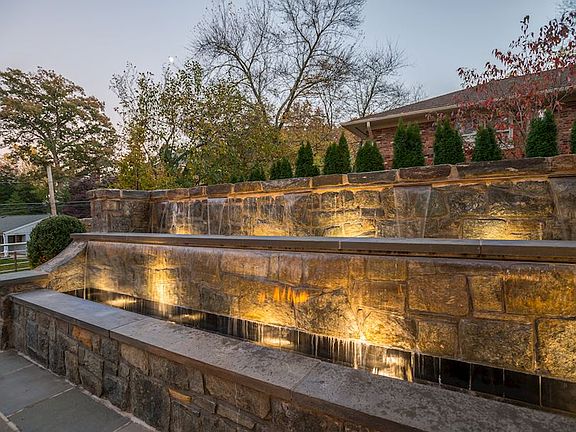 Stone waterfalls & prof landscaping + lighting