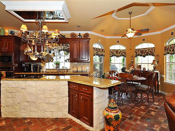 The kitchen is a chef's delight...island with ample granite counter space, cabinets (some with pull-