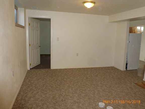 Living room showing kitchen & bedroom entances