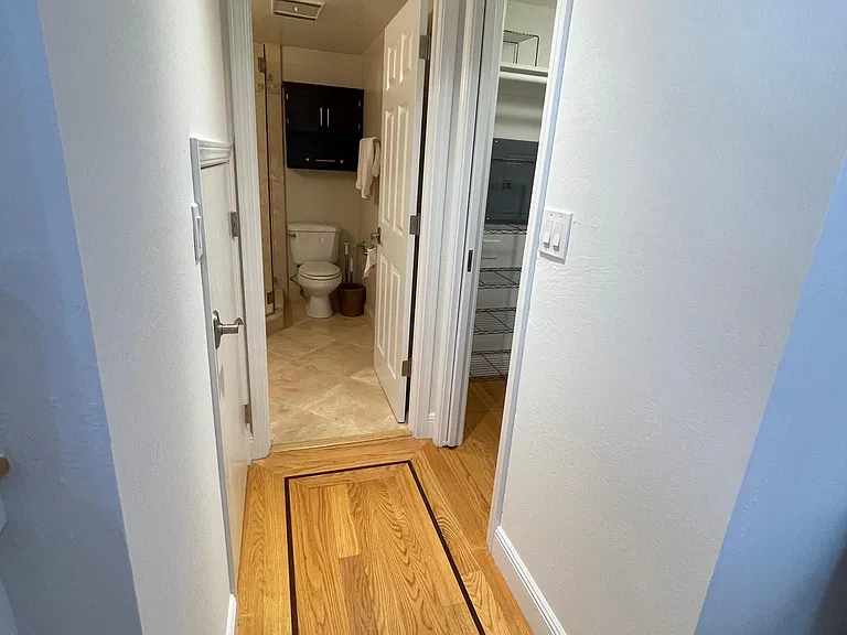 Hallway separating the bathroom/shower/Laundry Room/Storage Closet ... from the main living areas.