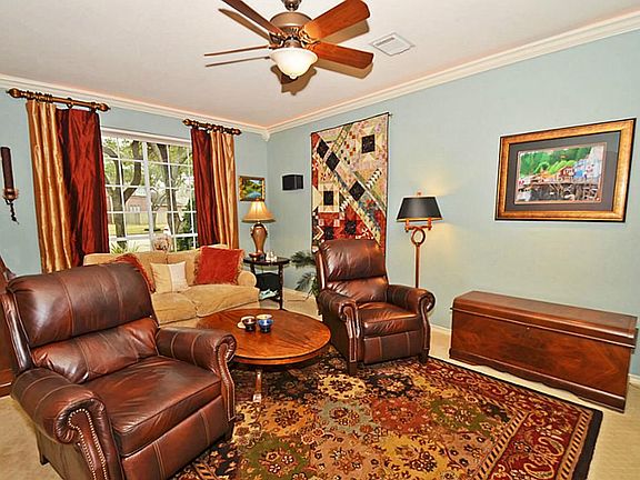 The Formal living room  Is set up as a media room. There are automatic room darkening blinds.