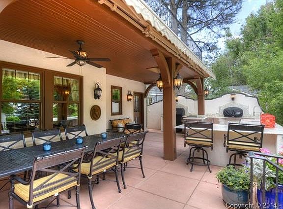 Dining area and outdoor kitchen. Outdoor kitchen features slab g