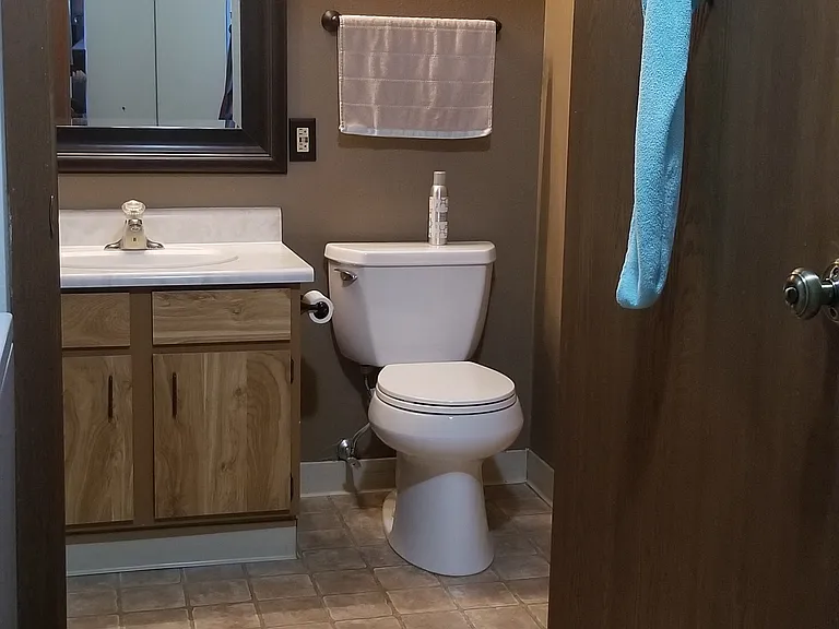 This picture shows the third section of the bathroom as seen from a walk-through closet that connects with the Master Bedroom.