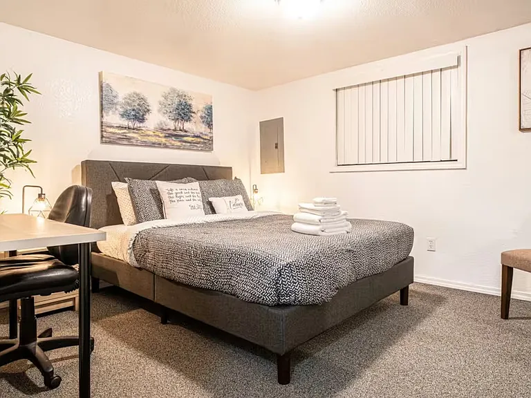 Bedroom 1 includes a queen-sized bed with memory foam mattress for a comfortable night sleep, an air-conditioner (kept in the bedroom closet during winter as the room stays cool) and a computer desk for working from home.