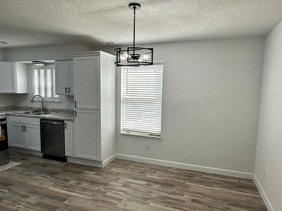 Main level with new vinyl plank flooring, breakfast room with new light fixture.