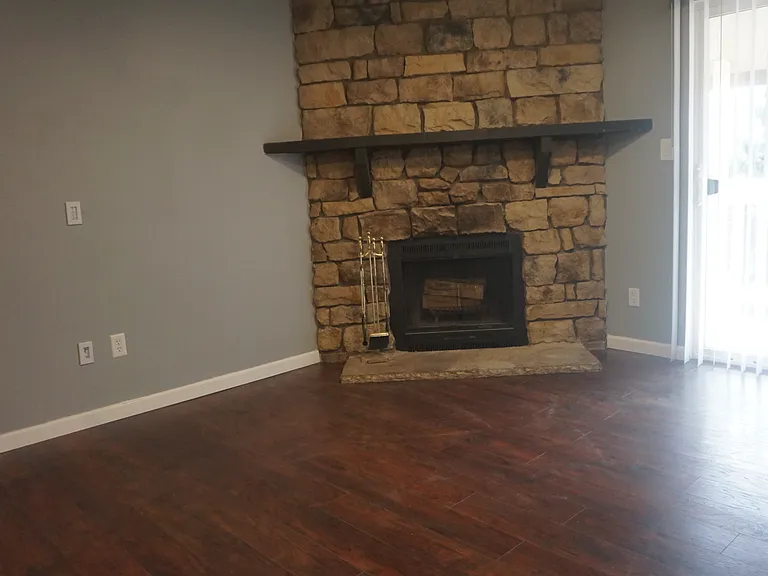 Cozy fireplace with adjacent patio.