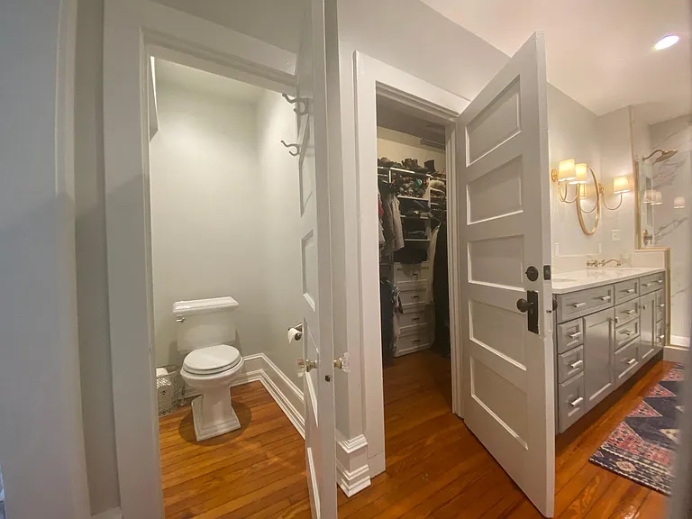 Primary bathroom showing door to toilet space and door to walk-in closet (closet space runs the full length of the sink vanity wall) (2nd floor)