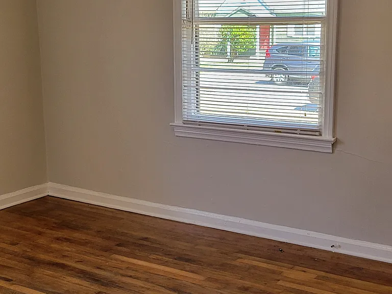 master bed room with beautiful hardwood floors