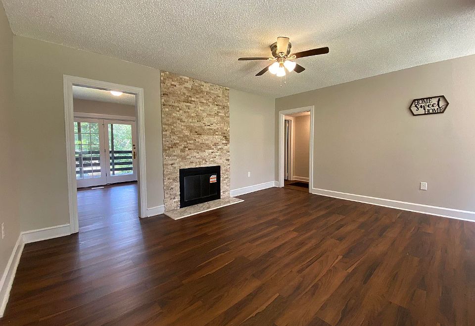 Living room. All fresh paint. New flooring. New stonework around the non-working decorative only fireplace.