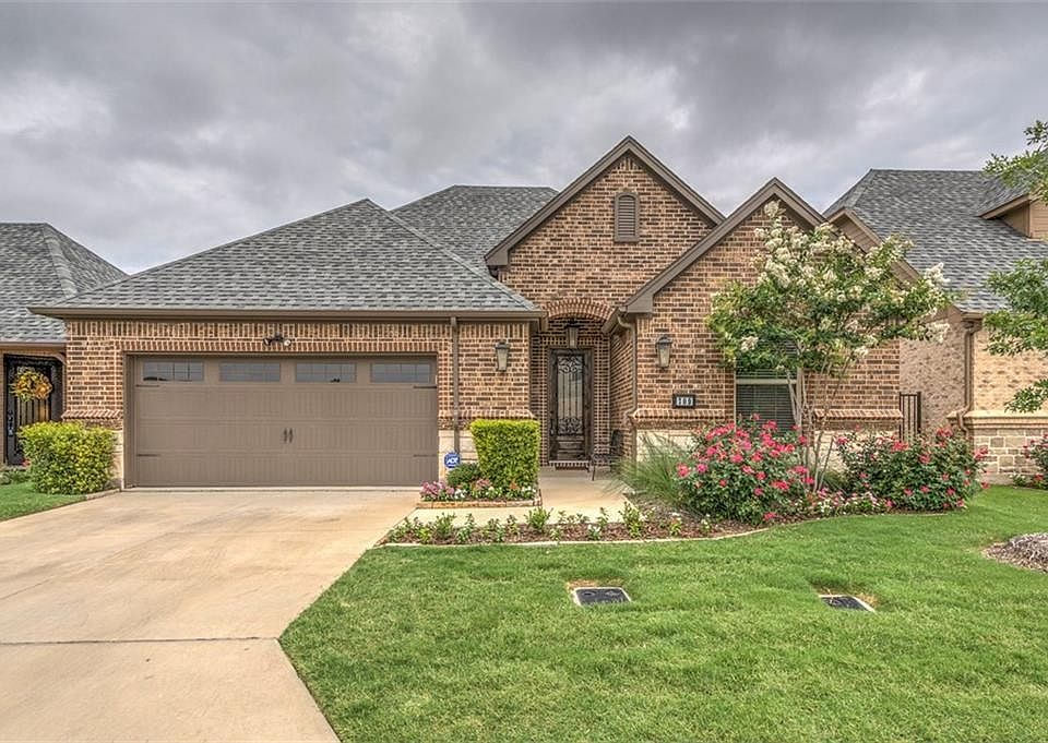Single family condo. All brick construction. Covered porch with iron, glass & wood door. Oversized garage with garage door opener. Exterior of home & landscaping is fully maintained by COA.