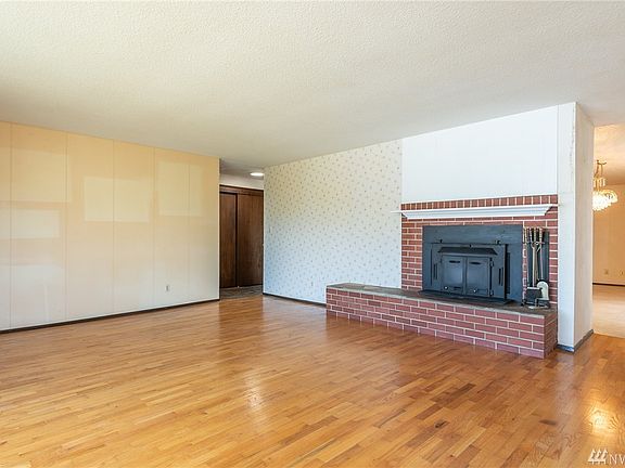 Wood stove insert in large open living room.