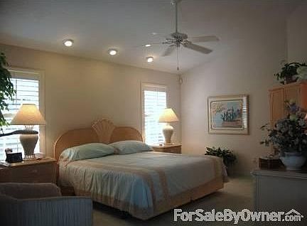 Master Bedroom : Bedroom is spacious with a valted ceiling and french doors.