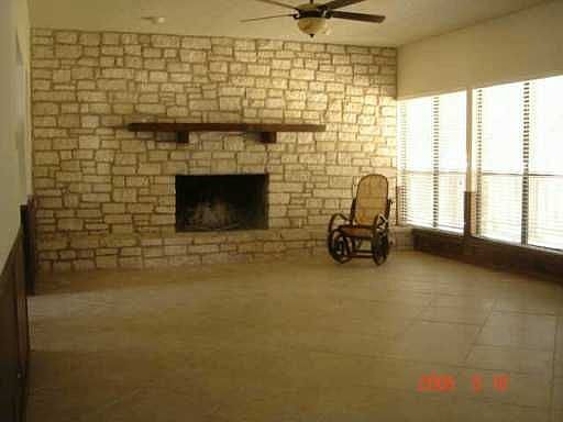 Rock walled fireplace and hard tile floors