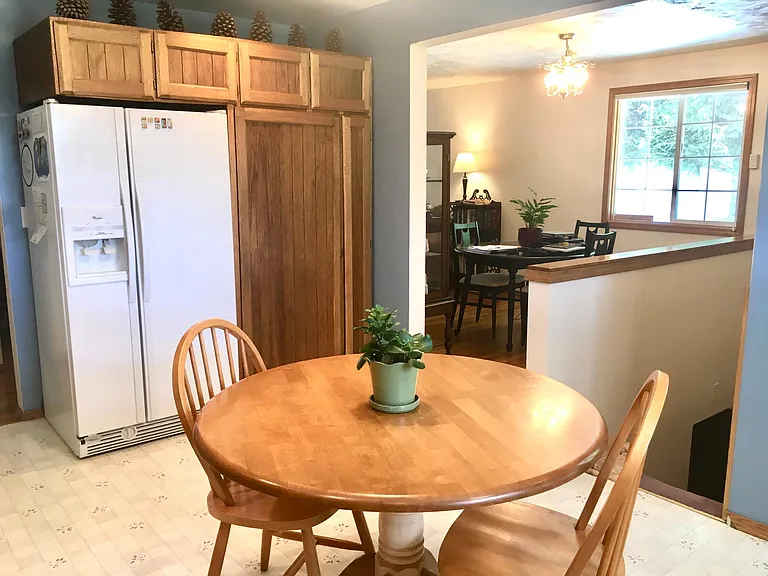 Large pantry cabinet next to the refrigerator, and a broom closet too!