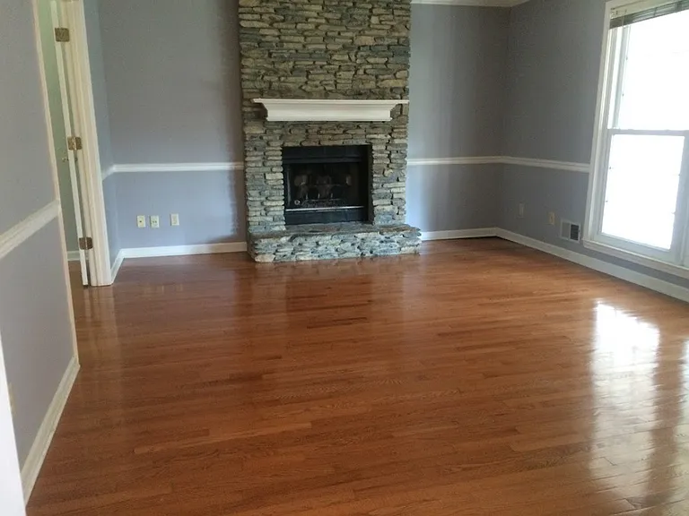 New paint! Shows the room unfurnished with moldings and hardwood floors. Beautiful light!